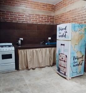 a kitchen with a refrigerator with a map of the world at Temporario Jujuy Campo in Lozano