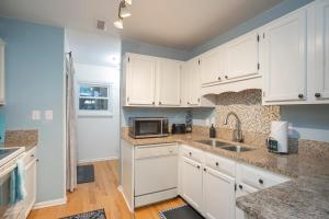 a kitchen with white cabinets and a microwave at Fresh in Franklin in Franklin