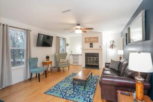 a living room with a couch and a fireplace at Fresh in Franklin in Franklin