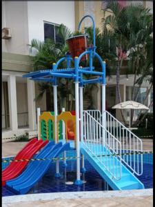 a playground with a slide in front of a building at Privê das Thermas 01 - Ar Split nos 2 quartos, ventilador na sala, purificador Soft gelada natural in Caldas Novas