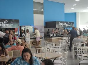 a group of people sitting at tables in a restaurant at Riviera Thermas Park in Caldas Novas