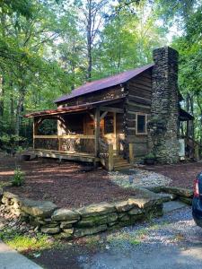 a log cabin in the middle of a forest at 1850’s Settlers Cabin at Wethero Ridge & Theater in Hendersonville
