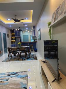 a dining room and kitchen with a table and chairs at Ana Homestay in Batu Pahat
