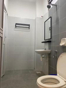a bathroom with a toilet and a sink at Ana Homestay in Batu Pahat