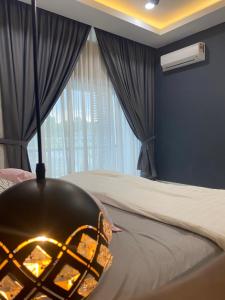 a bedroom with a bed with a fire pit at Ana Homestay in Batu Pahat
