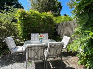 a table with four chairs and a vase of flowers on it at Character & new CNZhouse with quiet in Christchurch +22 photos
