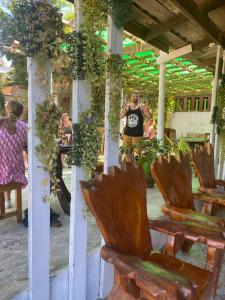 a man standing in a pavilion with chairs and plants at Veranda Lanta Resort in Ko Lanta