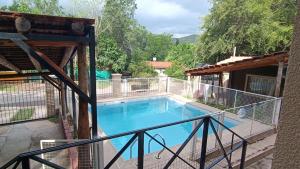 a view of a swimming pool from a balcony at Cabañas Los Pinos in Potrero de los Funes
