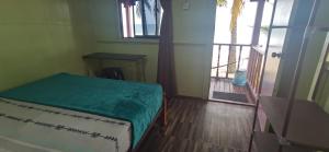 a room with a bed and a door to a room at Permata Beach Chalet in Kampong Juara