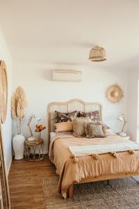 a bedroom with a large bed with pillows on it at Sunsets on Martyrs Luxury Coastal Beach House Peterborough in Peterborough