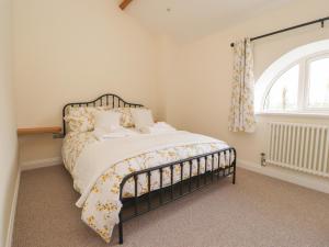 a bedroom with a bed and a window at Thy Owd Sty in Preston