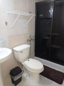 a bathroom with a toilet and a shower and a sink at Doña Nancy in Panama City
