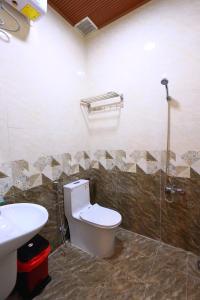 a bathroom with a toilet and a sink at Cẩm Tú Villa Đà Lạt in Da Lat