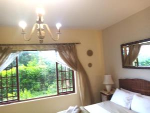 a bedroom with a bed and a window at Sea Valley Villa in Port Alfred
