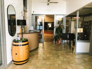 a store with a barrel on the floor of a building at Hunter Valley Travellers Rest Motel in Cessnock