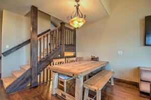 a dining room with a wooden table and stairs at 5-Star Finishings Townhome, Minutes from World Class Ski Resorts, Hot Tub home in Silverthorne