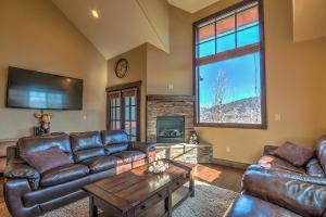 a living room with leather furniture and a fireplace at 5-Star Finishings Townhome, Minutes from World Class Ski Resorts, Hot Tub home in Silverthorne