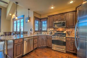 a kitchen with wooden cabinets and stainless steel appliances at 5-Star Finishings Townhome, Minutes from World Class Ski Resorts, Hot Tub home in Silverthorne