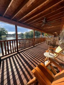 a large wooden deck with chairs and a table at Olde Mill Inn of Clarkston in Clarkston