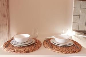 two bowls and plates sitting on a table at My Little Suites in Ermoupoli