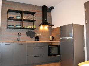 a kitchen with a stainless steel refrigerator and a sink at Residence Vlčice in Pec pod Sněžkou