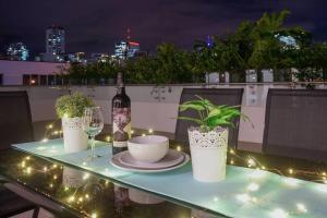 a table with a bottle of wine and a plate and a glass at Central Brisbane2BedsPark+Super big balcony! in Brisbane