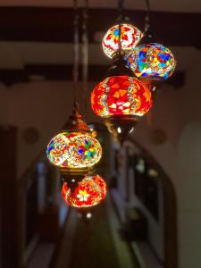 a group of colorful lights hanging from a ceiling at Aryaf hostel in Nizwa