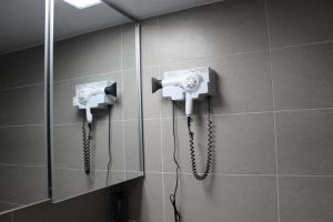 a bathroom with two phones on the wall at Fine and You Ocean City in Donghae