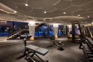 a gym with treadmills and weights in a building at [5-STAR Facilities] ARTE Mont Kiara Luxury Duplex in Kuala Lumpur