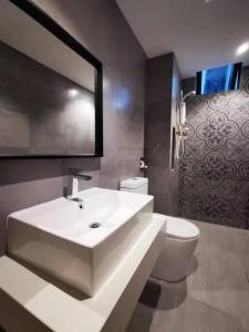 a bathroom with a white sink and a toilet at [5-STAR Facilities] ARTE Mont Kiara Luxury Duplex in Kuala Lumpur