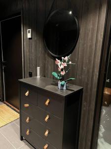 a bathroom with a sink and a mirror on a dresser at Kikut Alpin Lodge - Ski In/Ski Out - Ny 2022 in Geilo