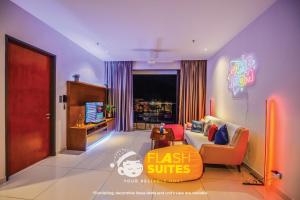 a living room with a couch and a tv at Geo38 Premium Suites at Genting Highlands in Genting Highlands