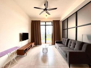 a living room with a couch and a ceiling fan at Ins Suite @ The Quartz Residence-Infinity Pool in Melaka