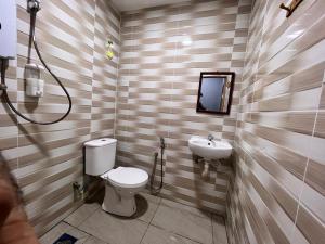 a bathroom with a toilet and a sink at Hotel Yasmin in Brinchang +70 photos