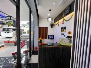 a counter in a restaurant with a clock on the wall at Hotel Yasmin in Brinchang