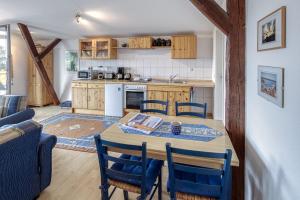 a kitchen and dining room with a table and chairs at Ferienwohnung " Müritzblick " in Waren