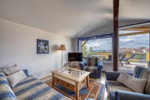 a living room with a couch and a table at Ferienwohnung " Müritzblick " in Waren