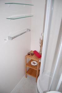 a bathroom with a shower and a wooden table at Ferienhaus Bergblick am See in Waldkirchen