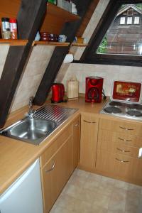 a small kitchen with a sink and a stove at Ferienhaus Bergblick am See in Waldkirchen