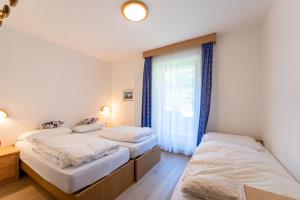 Postel nebo postele na pokoji v ubytování Berg Hotel Latemar Spitze