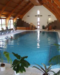 a large swimming pool in a large building at Ágnes Hotel in Hévíz