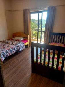 um quarto com uma cama e uma janela com vista em Edrose Condo Unit Rental em Baguio