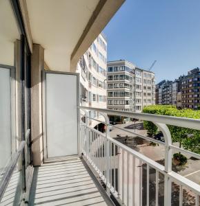 a balcony with a white door on a building at La Corneille en Mer in Ostend