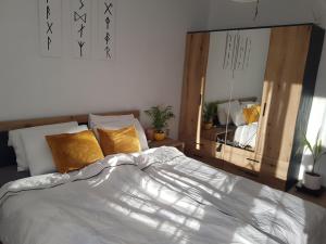 a bedroom with a bed and a large mirror at Уютен двустаен апартамент с прекрасна гледка in Stara Zagora