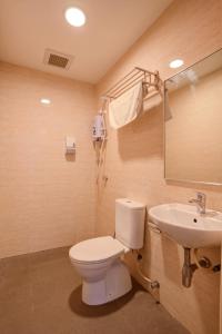 a bathroom with a toilet and a sink at GM Grand Moments Bandar Sunway in Petaling Jaya
