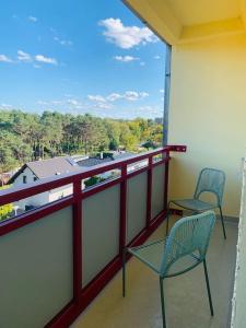 balcón con 2 sillas y vistas a un edificio en cozy Apartment in Cottbus Work 2 en Cottbus