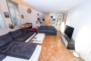 ein Wohnzimmer mit einem Sofa und einem TV in der Unterkunft Anna-Maria : Grand appartement 10 personnes+parking privé -Actif+ Location- in Marseille