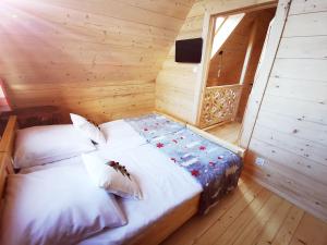 a bedroom with a bed in a wooden cabin at Heidi in Zakopane