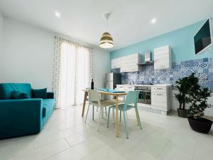 a kitchen and dining room with a table and chairs at Sunlands 50 meters from the sandy beach with wifi in Avola