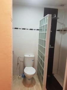 a bathroom with a toilet and a glass wall at Appartements agadir 2,5km de la plage in Agadir